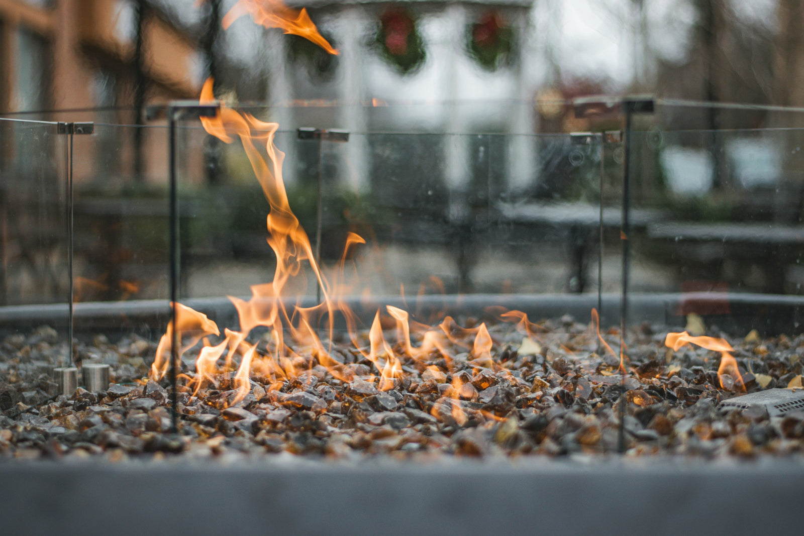 Fire table vs fire pit comparison — modern outdoor fire feature on a patio at dusk
